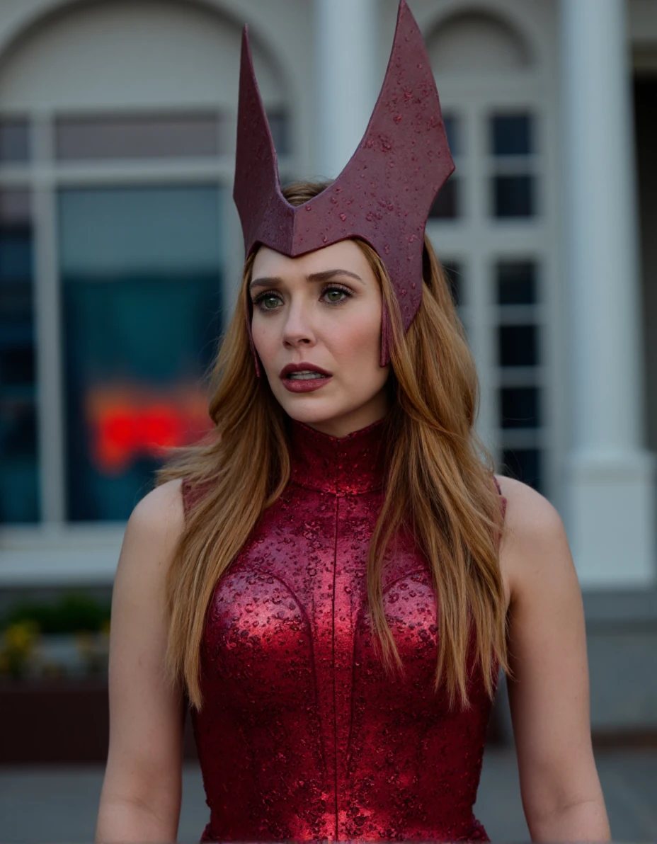 The image is a high-resolution photograph featuring a woman standing in an outdoor setting with a modern architectural backdrop. The woman, who appears to be in her late 20s to early 30s, has light skin and long, wavy, golden-brown hair that cascades past her shoulders. She is wearing a red, high-necked costume with intricate, metallic armor-like patterns, which accentuates her slender physique. Her eyes are a striking green, and she has a serious, contemplative expression.
The woman's head is adorned with a pair of distinctive, red, winged headpieces that resemble the antennae of an insect, with a metallic sheen. These headpieces are connected to a dark, leather-like headband that wraps around her forehead, adding to her mysterious and otherworldly appearance.
The background is a large, ornate building with arched windows and a white, columned facade. The windows are painted with a deep, rich blue and red hue, casting a dramatic light on the scene. The overall color scheme of the image is predominantly dark and muted, with the exception of the vivid red and blue tones from the windows, which add a sense of depth and contrast.,Elizabeth Olsen,<lora:Elizabeth Olsen_Flux_V1:0.93>