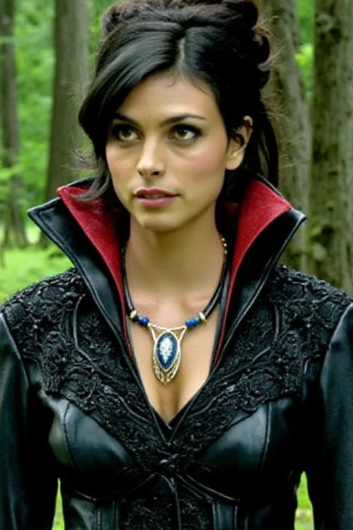 The image is a photograph of a ohwx woman standing outdoors in a lush, green forest. She has medium-dark skin and dark, voluminous hair styled in a loose updo with some strands framing her face. Her eyes are a deep brown, and she has full, slightly parted lips. She is wearing a dark, high-collared coat made of a shiny material, likely leather, with intricate, black, embroidered detailing around the collar. The collar has a red lining that contrasts sharply with the black. Around her neck, she wears a distinctive necklace with a large, ornate pendant featuring a white and blue design. The pendant has a central, intricate, blue design surrounded by white and blue beads. The background is filled with tall, thick trees with green foliage, creating a dense, natural environment. The lighting in the photograph is natural, indicating it was taken during daylight hours. The overall mood of the image is serious and slightly mysterious, with the woman's expression suggesting contemplation or focus.