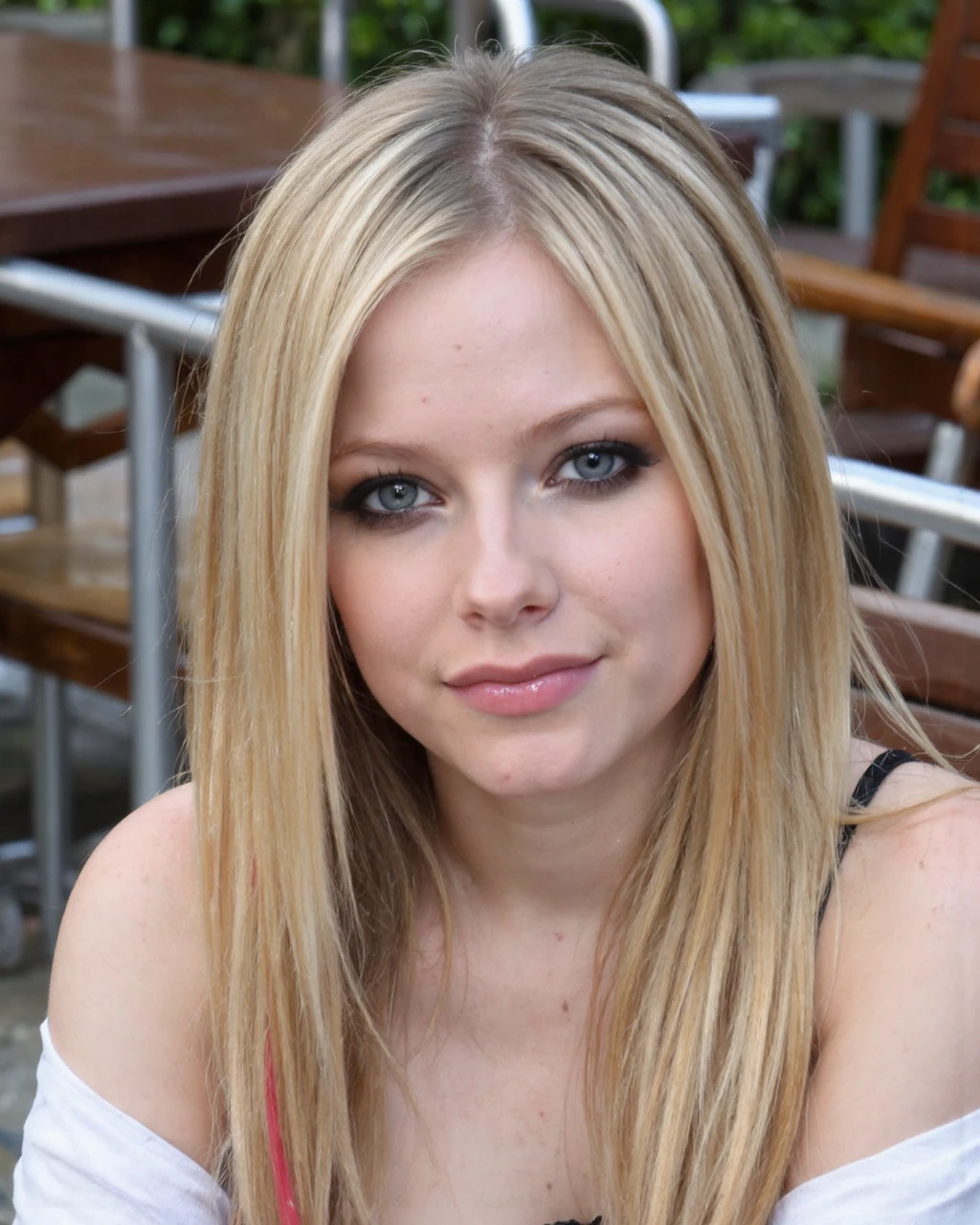 This photograph features avril_lavigne with light skin and straight, long blonde hair, sitting in an outdoor setting. She has striking grey-blue eyes, accentuated with subtle makeup, and full, naturally pink lips. Her facial expression is calm and slightly seductive, with a direct gaze at the camera. She is dressed in a white, off-the-shoulder top, revealing her collarbone, and a black, sleeveless dress that is slightly visible at the bottom.
The background consists of a mix of wooden and metal outdoor furniture, including chairs and tables, with some greenery visible in the blurred background. The setting appears to be a patio or garden area, with a mix of natural and man-made elements. The lighting is natural, likely from the sun, giving the photograph a warm and inviting ambiance. The texture of the photograph is crisp and detailed, capturing the softness of her skin and the smoothness of her hair. The overall composition is well-balanced, with the subject's face centered in the frame, and the background softly blurred to keep the focus on her.