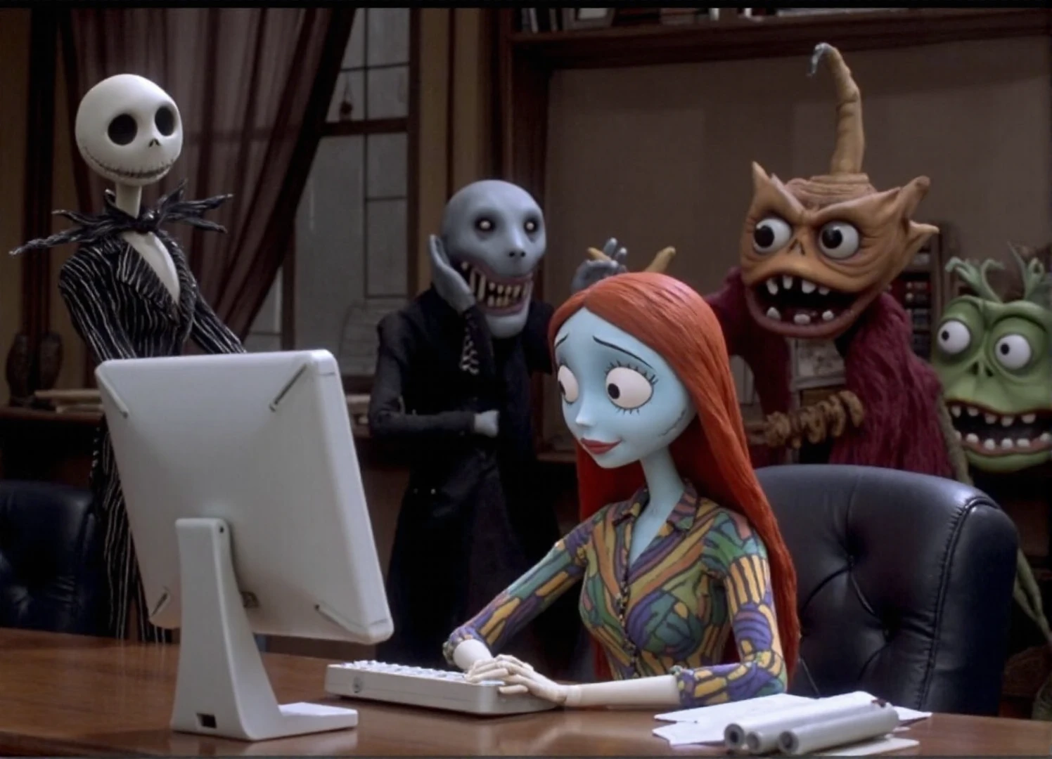 Stop motion film showing Jack Skellington and Sally puppets working at computer at the office in style of Tim Burton. Nightmare before Christmas movie. Some monsters at background.