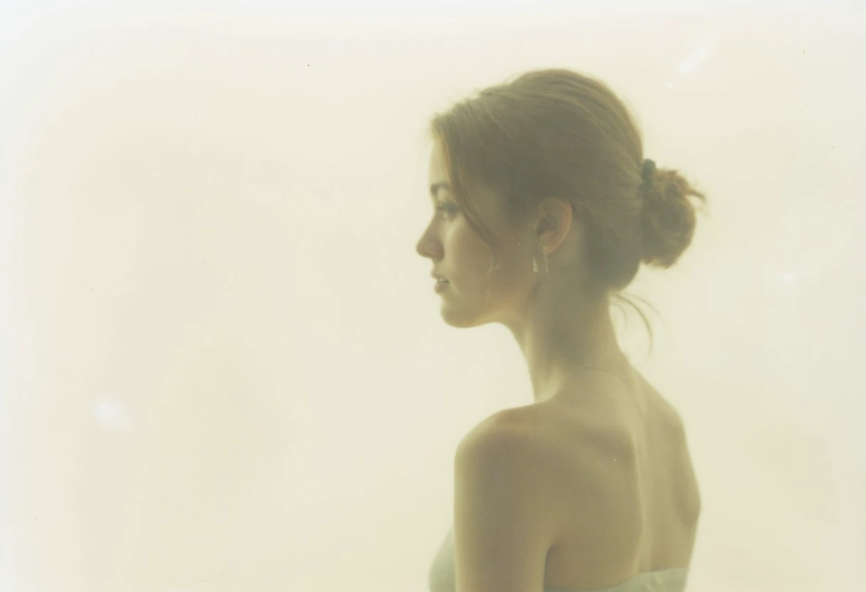 an aesthetic, minimalist depiction of a female profile in side view. The focus is on the soft contours and calm, monochromatic tones. The scene feels mystical and dreamy, almost as if viewed through a delicate mist, with gentle light accentuating the silhouette. The background is diffuse and creamy white, drawing attention to the elegant simplicity of the figure.