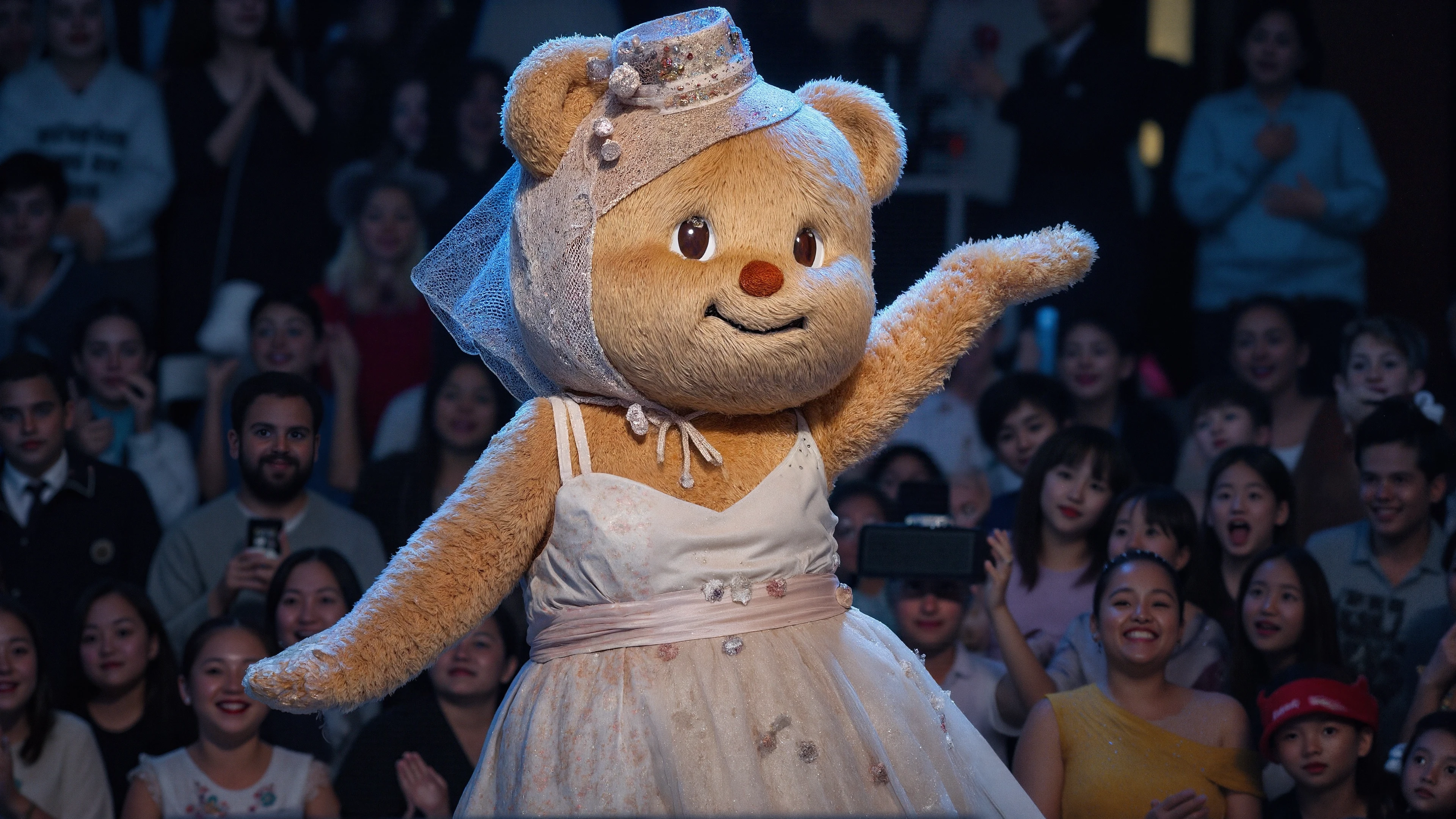 Butterbear, Thai, fur, realistic, fuzzy, furry, natural realistic bear fur, fantasy character, fun, whimsical, she is wearing facinator hat and a elegant dress and is posing seducatively on stage at a concert, desktop wallpaper, full body in frame, RAW photo, detailed photograph,8K,extreme photography,masterpiece,trending, pulls the viewer in,film grain,photographed on a Sony A7R IV,18mm F/1.7 cine lens,(highly detailed, intricately detailed),HDR, cinematic film still, highly detailed, high budget, cinemascope, colourful