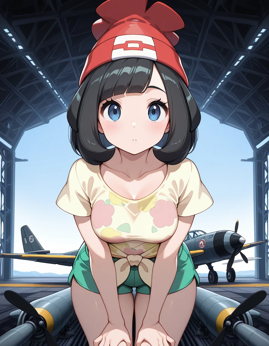 masterpiece, best quality, amazing quality,, <lora:pokemon-selene-illustriousxl-lora-nochekaiser:1>, selene, selene (pokemon), black hair, blue eyes, short hair, bangs, blunt bangs, mature female, medium breasts,, beanie, collarbone, green shorts, hat, red headwear, shirt, short sleeves, shorts, tied shirt, yellow shirt,, hands on own knees, hangar, planes, large, storage, aviation, cowboy shot, solo, looking at viewer