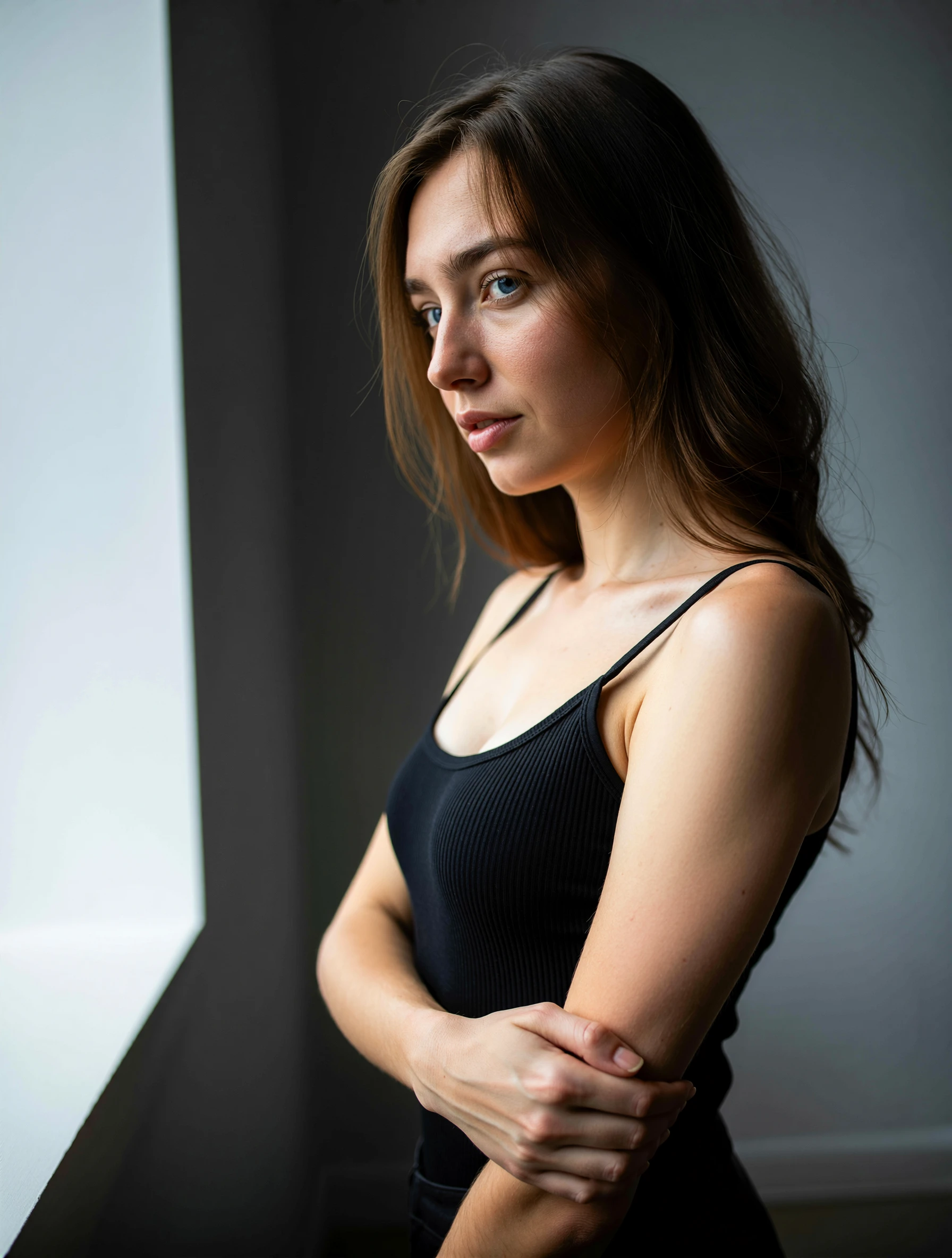 The 21yo caucasian woman stands with her brunette hair cascading in loose waves across her face, framing her features like a natural curtain. Her soft, rounded cheeks and delicate jawline suggest youthfulness, while the slight tilt of her head adds an air of quiet introspection. Her blue eyesâdeep and unblinkingâhold a contemplative gaze, their irises catching the light with a subtle sheen. A faint, almost imperceptible smile curves her lips, as if caught between thought and restraint. The hair clings to her temples in damp strands, hinting at recent movement or a breeze, while the skin beneath glows with a soft, natural luminescence. Her posture is relaxed yet poised, fingers lightly grazing her arm as though holding an invisible thread of focus.  
The shot locks in on her face and upper chest, framed by a shallow depth of field that blurs the edges of her hair and shoulders into a gradient haze. Natural light spills from the left, casting a warm glow across her cheekbones and highlighting the curve of her brow, while shadows pool beneath her eyes to deepen the sense of quiet reflection. The background is a near-empty studio spaceâneutral gray walls and a single lamp casting long, soft lines that accentuate her contours without distracting. The mood is subdued yet alive, the interplay of light and shadow lending a tactile quality to her expression, as if the viewer can feel the weight of her thoughts pressing against the edges of the frame.  
Rendered in high-resolution realistic photographic style, the image captures every nuance of textureâlints of hair catching stray light, the faintest freckle along her nose, the soft sheen of sweat on her brow. The focus sharpens on her eyes and lips, their details rendered with clinical precision, while the rest of the scene dissolves into a blur of muted tones. The atmosphere is crisp yet intimate, as though the camera lingers just close enough to touch the silence between her thoughts. No filters or artificial enhancements; only the raw, unflinching capture of a moment suspended in quiet contemplation.