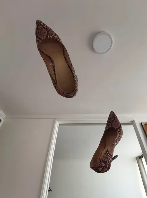 A world where woman high heels and shoes start to walk by themselves, as if an invisible nude woman were wearing them
