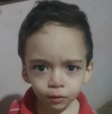 There is a young boy with a red shirt and a tie, ultra realistic face, ultra realistic portrait, very realistic face, ultra realistic faces, extremely realistic face, lovely digital painting, extremely realistic faces, ultra realistic digital painting, detailed realistic face, hyper realistic face, ultra realistic faces, photorealistic portrait, realistic digital painting, hyper realistic faces. Smiling