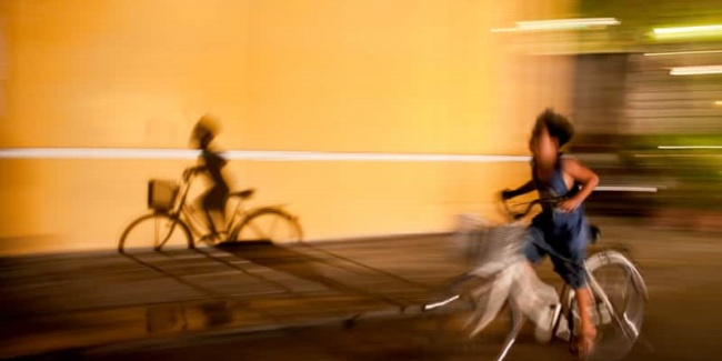 Camera panning of a boy riding a bicycle