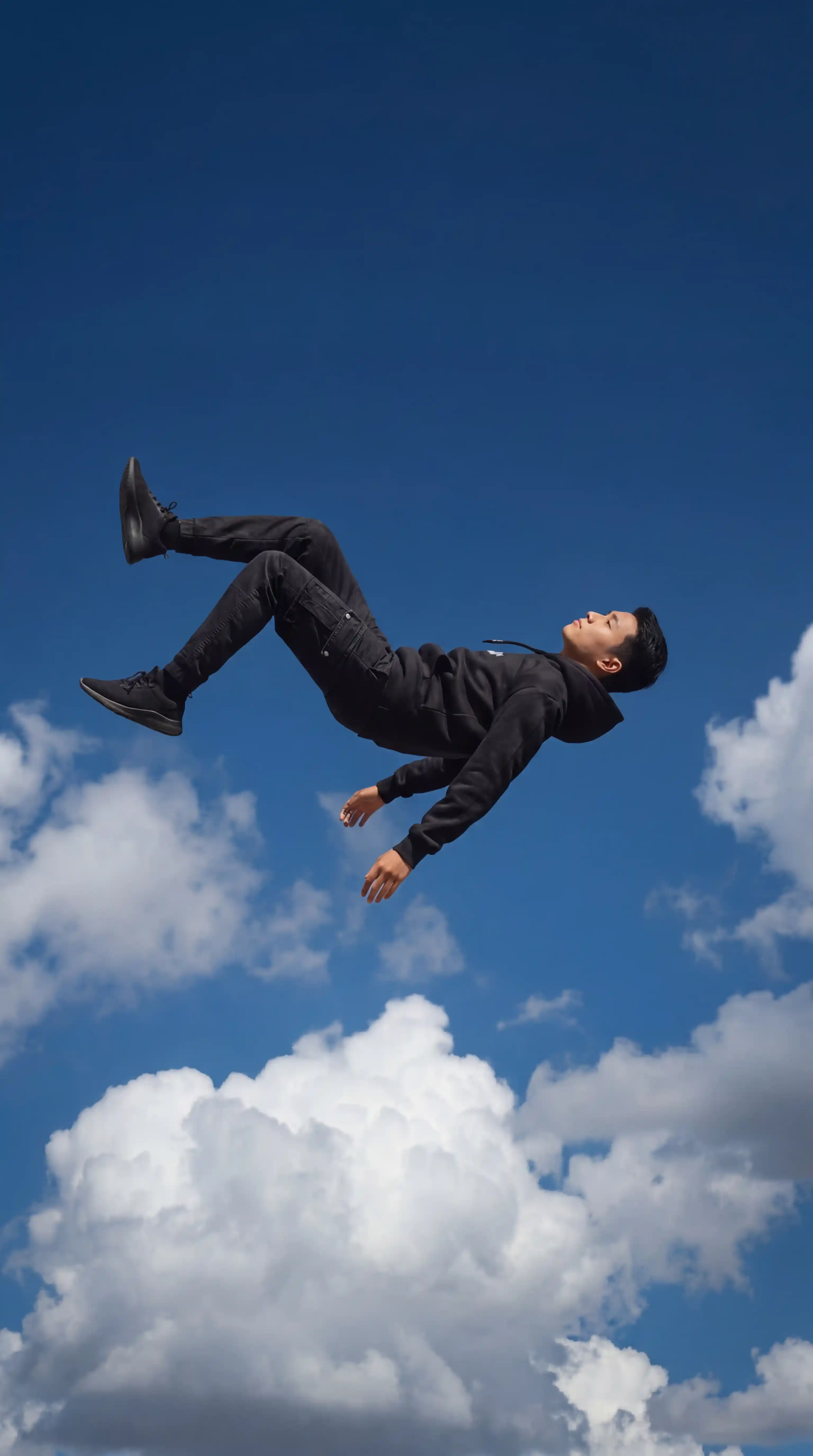 Hot Prompt for Grok โ Young Man Levitating Mid-Air Against Blue Sky Surrealist Photography