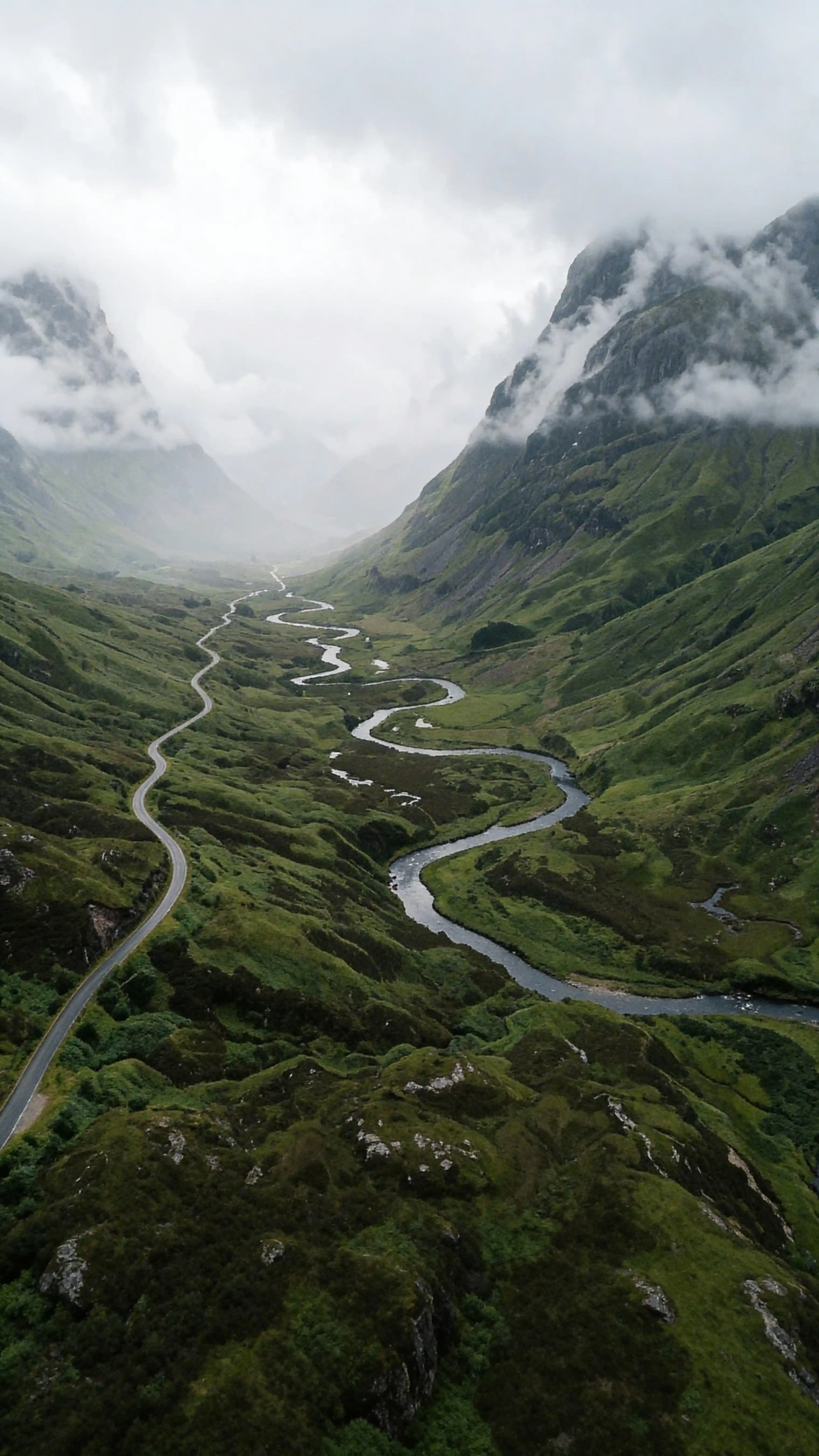 Aerial view of mist-wrapped Scottish highland valley with emerald hills, Nano Banana 2 landscape prompt