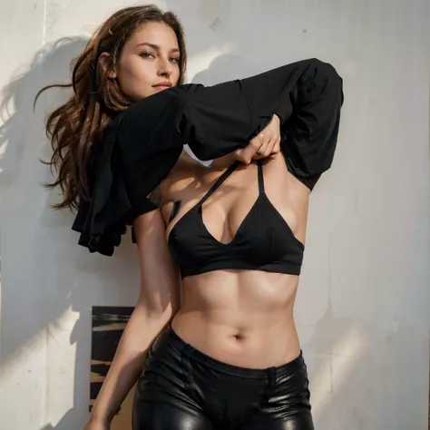 Female supermodel in a black sports bra and black leggings against a blank wall with a oil painting of an apple