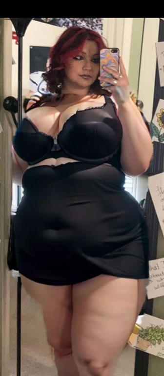 there is a woman that is taking a picture in the mirror, she is wearing a black dress, full body picture, taken in the early 2020s, cute black dress, zoomed out full body, wearing a black dress, she has a jiggly fat round belly, taken in the late 2000s, Bi...