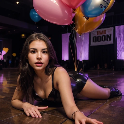 Pretty 20 year old girl on the dance floor full of 10,000 very pretty latex balloons on the floor