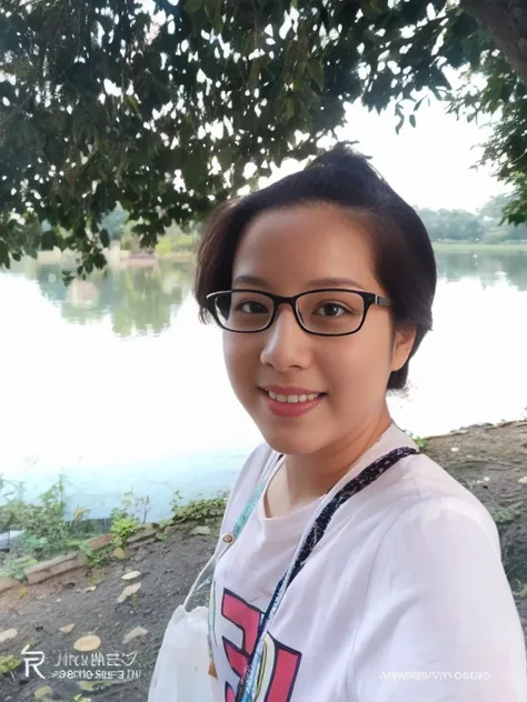 Young woman wearing a bright colored shirt In the background there is a flower garden.