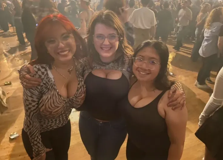 three women standing next to each other in a room full of people, non blurry, with tiny people, concert photo, not blurry, photo taken in 2 0 2 0, very grainy, very very low quality picture, profile pic, profile picture, very very low quality, by Bernie D’...