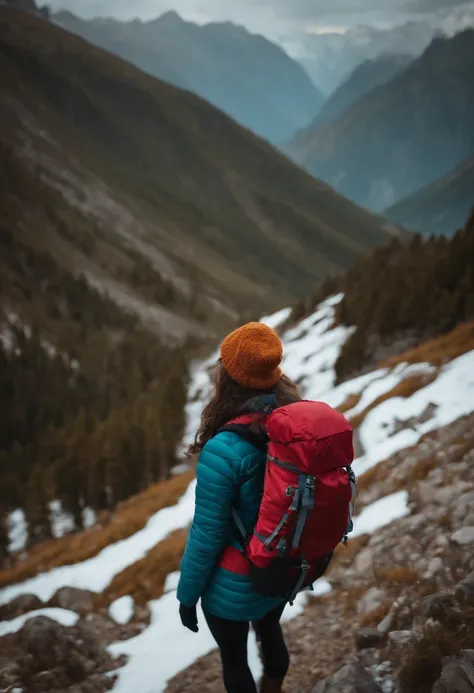 brunette woman in the mountains with backpack and gloves