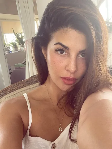 there is a woman that is sitting down with a necklace on, without makeup, gorgeous latina face, violet myers, selena gomez, sexy face, sexy gaze, kylie jenner, madison beer, 18 years old, taken in the early 2020s, no makeup wavy hair, dua lipa, instagram s...