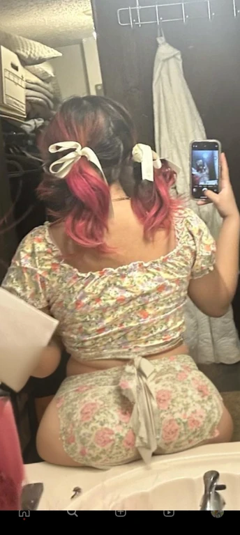 woman with pink hair taking a picture of herself in the mirror, wearing pink hair bow, pigtails, colorful pigtail, wearing underwear, with pink hair, wearing pink panties, back of the hair, roses in her hair, pink hair covered with hairpins, view from the ...