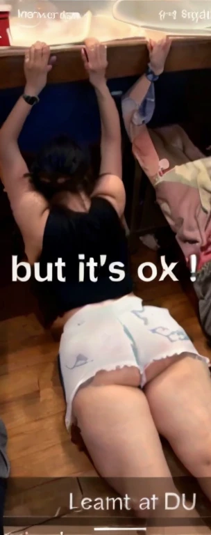 there is a woman laying on the floor with her legs up, her back is to us, booty shorts, exposed thighs!!!, tiktok video, obviously drunk, on knees, thighs!!!!!!, she is laying on her back, passed out, leaked footage, oops, laying on her back, pawg, ots sho...