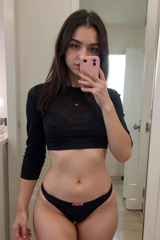 A mirror selfie of a girl in black crop shirt and pink  hipster brief
