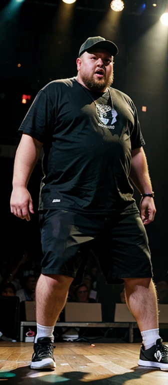 Slightly overweight guy on stage at a rap battle