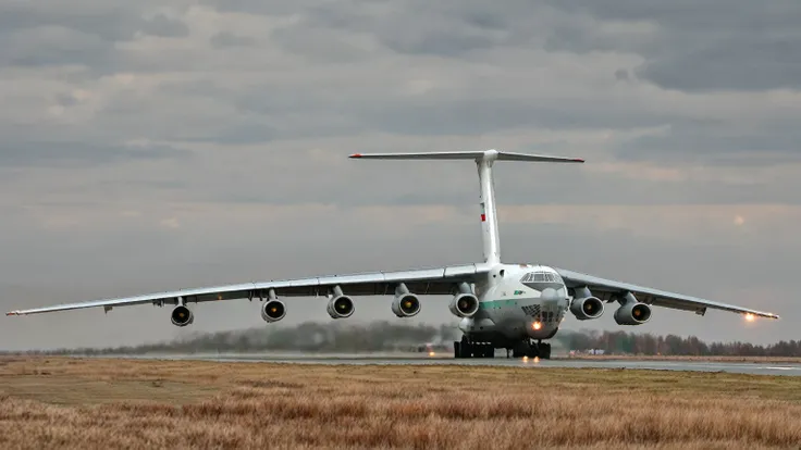 il_76 standing on runway, close up loaded by giant truck