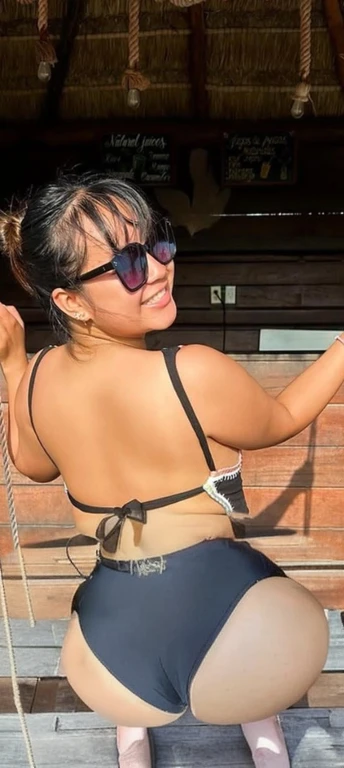 there is a woman in a bikini and sunglasses on a swing, wearing two - piece swimsuit, showing her shoulder from back, is wearing a swimsuit, in bikini, hot with shining sun, with sunglass, in the sun, with sunglasses, in a bikini, back pose, profile image,...