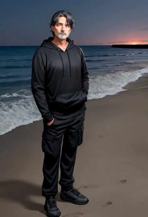 a 55 year old man with dark hair and blue eyes and a black hoodie and black cargo pants at night at the beach
