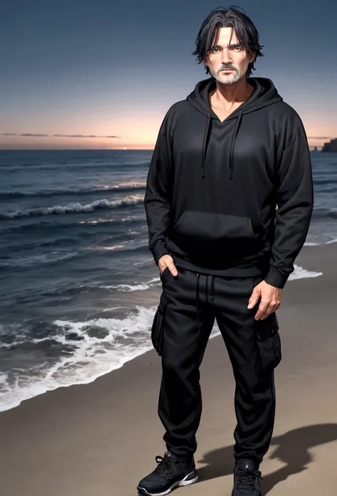 a 55 year old man with dark hair and blue eyes and a black hoodie and black cargo pants at night at the beach
