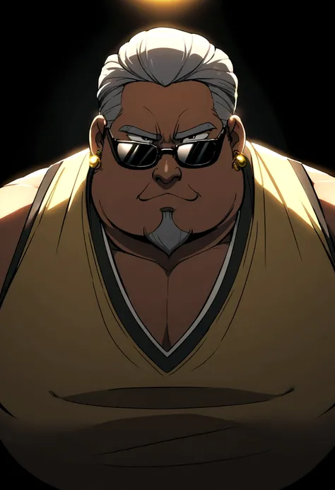 A plump man with gelled grey hair, wearing black sunglasses, a goatee, gold earrings, and a tan vest.