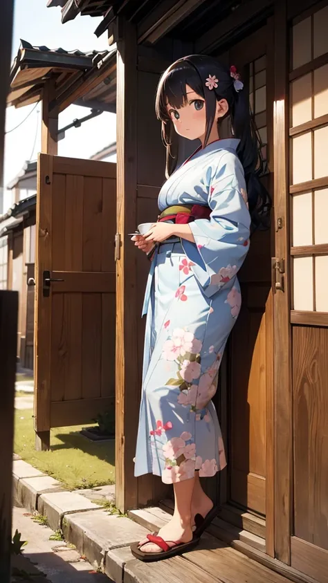 Teenage girl dressed in kimono having tea in front of door of old Japanese house