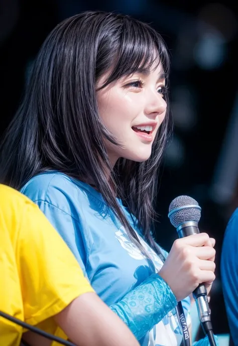 black haired woman wearing a blue shirt holding a mic