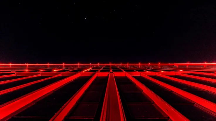 The rooftop has red lights, looking up at the highest floor at night