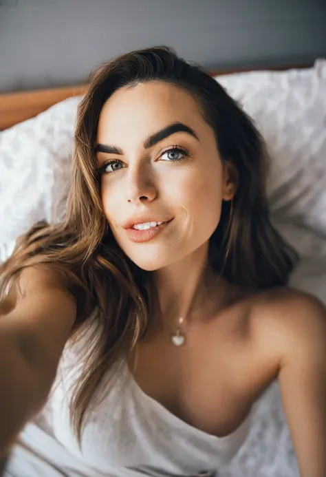 a 25-year-old woman a selfie in bed, blowing a kiss to the camera.