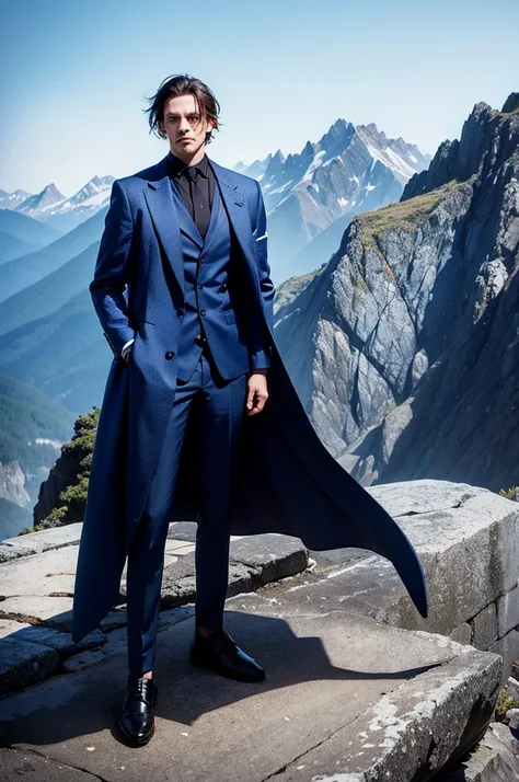 A man dressed in dark fantasy blue on top of a mountain range 