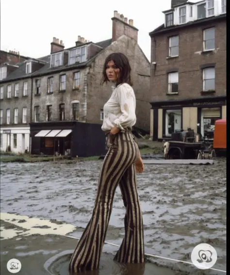 70s setting, film photo of girl in [muddy, dirty]  worn-out high leggings pants and blouse drowning in bog, flares