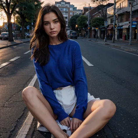 Female supermodel. Royal blue sweater. Sitting in the middle of road. Dim, soft lighting. Sunset.