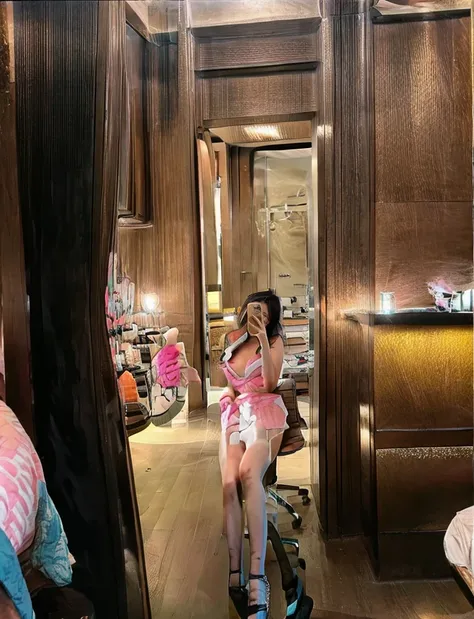 Sabrina Carpenter, smiling, white bra, pink skirt, selfie on mirror