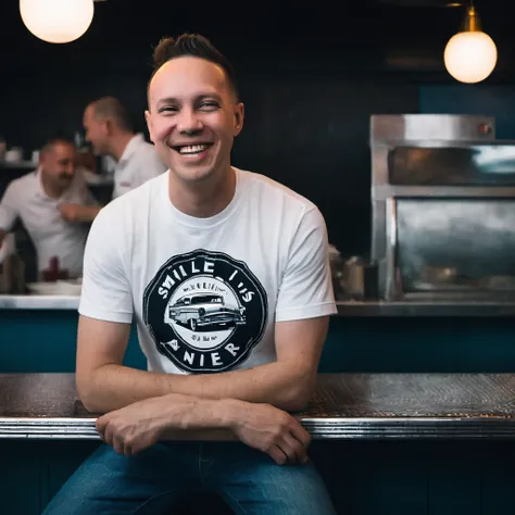 street photography photo of a man (Todder9), smile, happy, graphic logo t-shirt, hands in pocket, sitting in a dark 50s diner