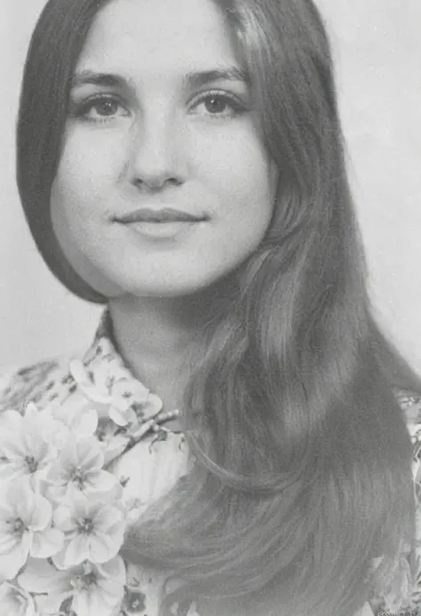 arafed photo of a young woman with long hair and a flower dress, a black and white photograph inspired by Gina Pellón, tumblr, Renaissance, old yearbook photo, in his early 30s, taken in the 1970s, 13 years, in his 20s, taken in the late 1970s