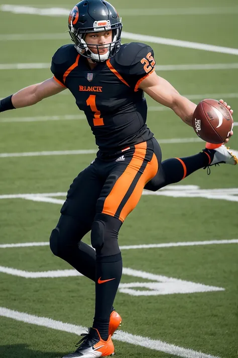 Football player in black and orange uniform with ball at his foot 