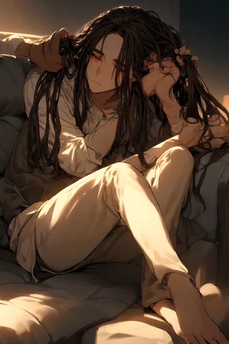 Boy with dreadlocked hair and red eyes, sitting on a sofa while stroking the hair of a boy lying on his legs, The boy&#39;s hair is long brown and his eyes are closed.