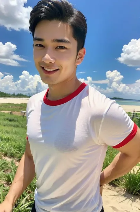 A handsome, muscular young Asian man looks at the camera. In a simple t-shirt white and red , Fieldside, grass, beach, sunlight