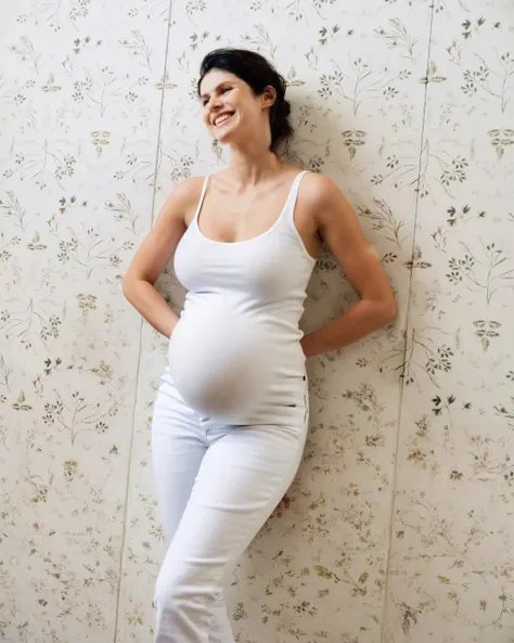 4lex4ndr4, high quality, pregnant, leaned against a wall, arms begind her back, smiling, tight white shirt and blue jeans