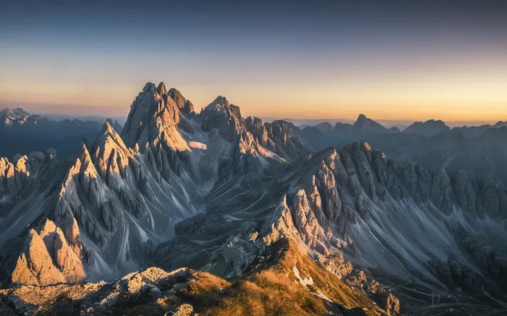 the view from the top of a mountain at sunset