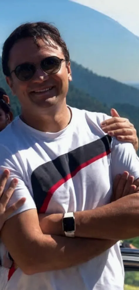 
man smiling with forest in the background