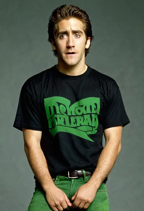 A young Jack Gyllenhaal, 20 year, frightened expression, no beard, black T-shirt, green jeans, in full