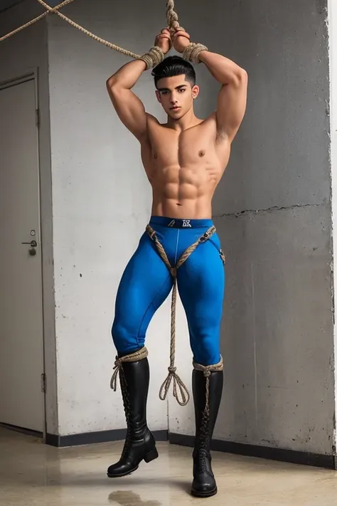 A handsome young Latino, military style hair, shirtless, six pack, 19 years old, full body, wearing blue spandex pants, black riding boots, bondage, BSDM, tied, steel harness, wrists and ankles tied, with a rope, arms and legs open, forming an X, to the wa...