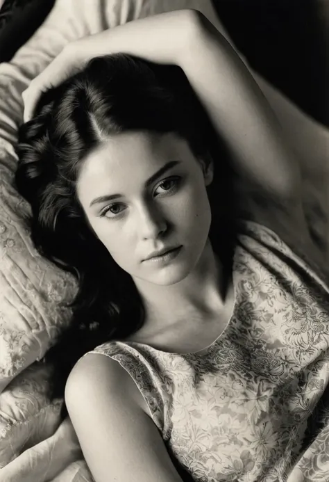 Vintage photo, A monochromatic, aerial view, grayscale image depicts a young woman lying on a bed. Her head is resting on the pillow while her left hand is under her head. Her face is slightly tilted upwards, with a contemplative and melancholic expression...