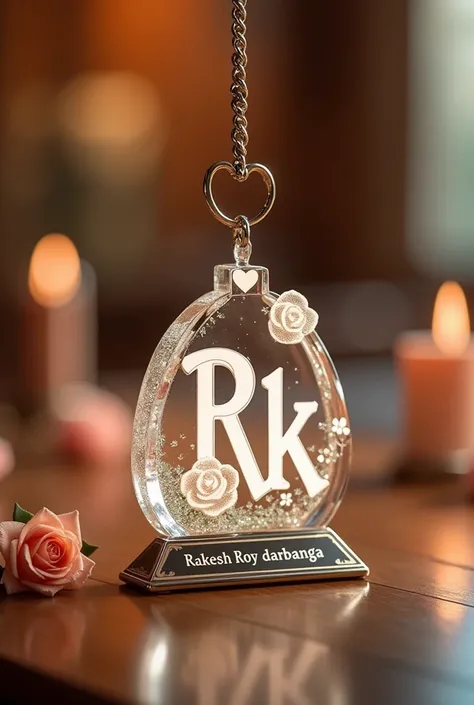 This image depicts a beautiful, glass white keychain and ornament featuring the letter "R.k" adorned with roses and hearts, placed beside a pink flower. Below the golden keychain, there is a name plate with the name"Rakesh Roy darbhanga" on it the clearly ...