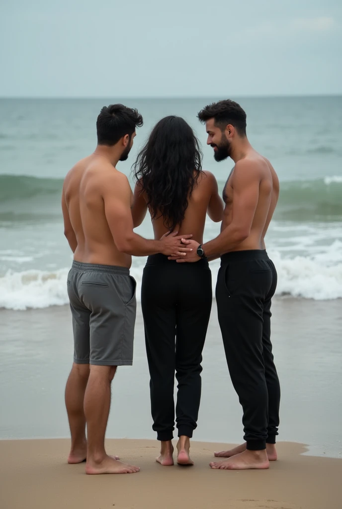 Black wavy hair on the beach, black sweatpants, Barefoot woman. 2 men touching woman&#39;s butt